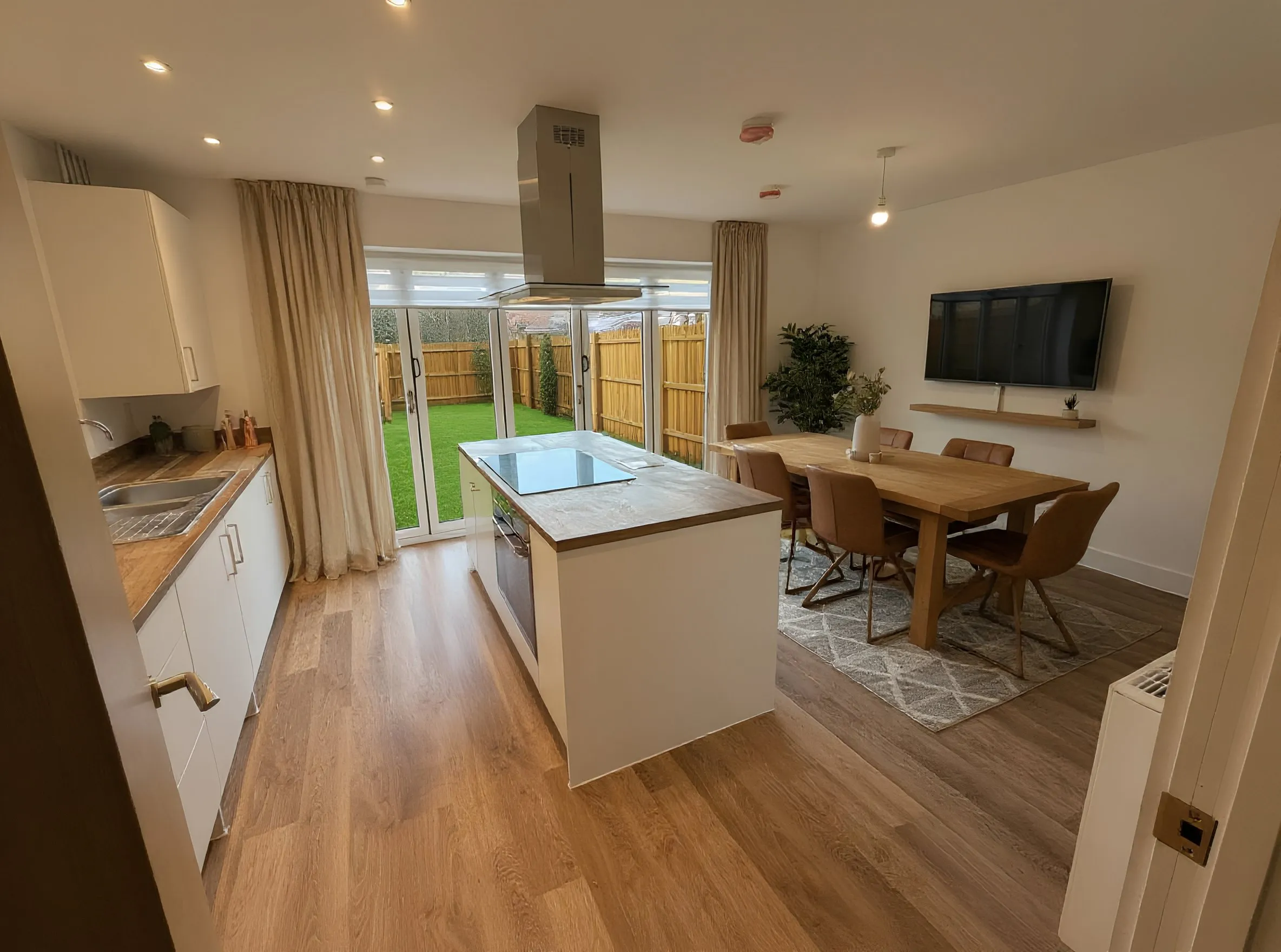 Scandi-styled new-build kitchen with bi-fold doors to the garden